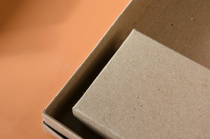 Cajas de cartón superpuestas sobre un fondo naranja