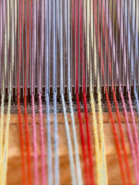 Hilos de colores tensados en un telar
