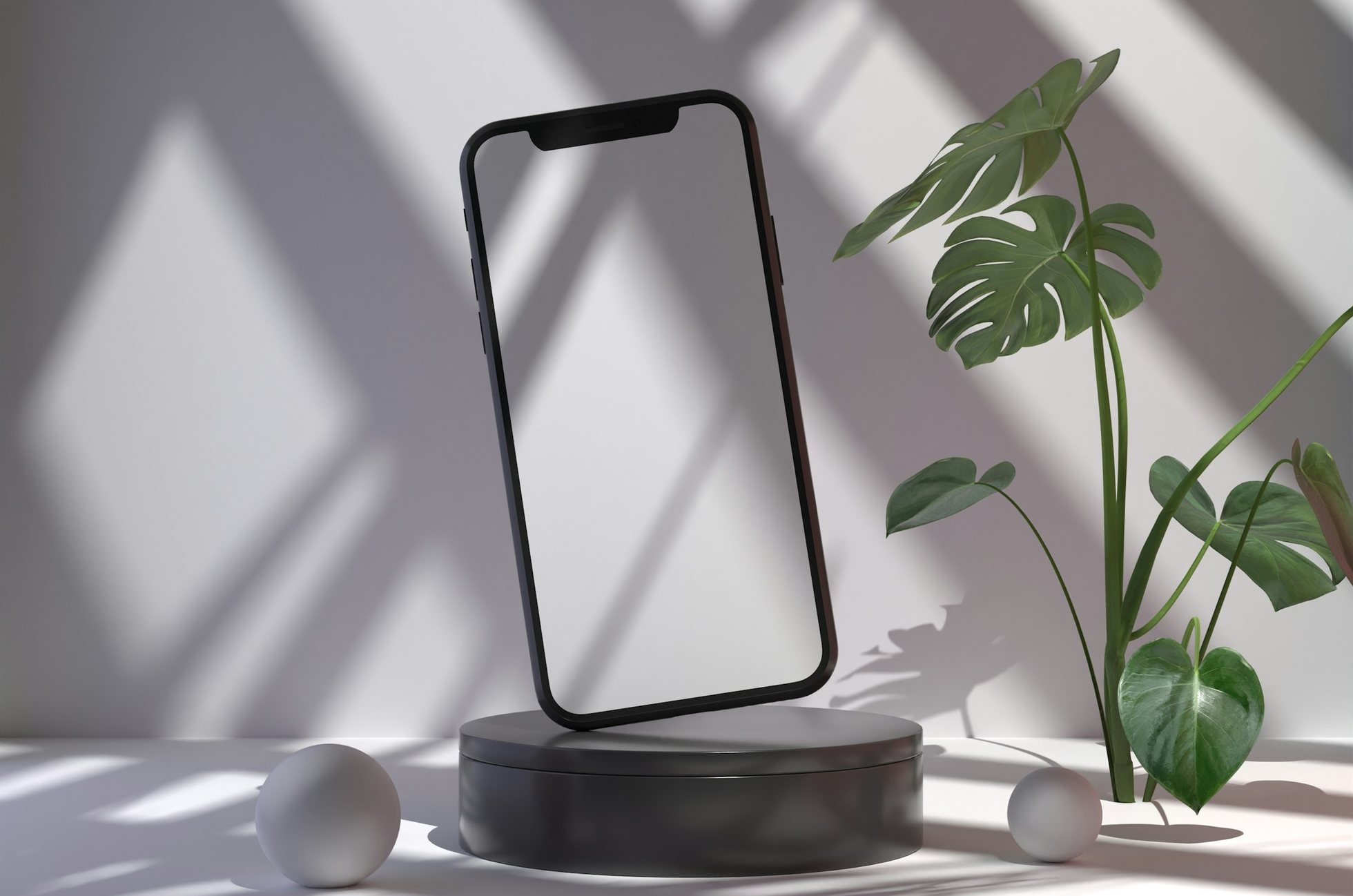 Un teléfono con la pantalla en blanco sobre una plataforma oscura, con la sombra de una ventana y una planta
