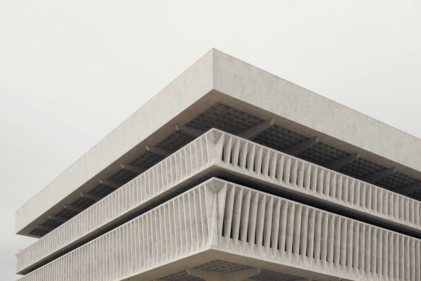Esquina de un edificio de hormigón con balcones calados