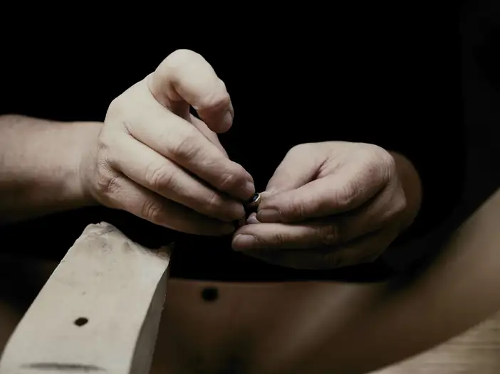 Manos que dan forma a una pieza de madera